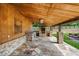 Inviting outdoor kitchen with stone countertops, sink, and built-in grill, ideal for al fresco dining and entertaining at 1780 Penn Camp Road, Douglasville, GA 30134