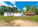 A sunny day showcases the exterior of the home and barn at 1780 Penn Camp Road, Douglasville, GA 30134