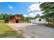 Exterior view of the home and barn; set on a sunny day at 1780 Penn Camp Road, Douglasville, GA 30134