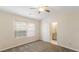 Bright bedroom with neutral walls, ceiling fan and carpet flooring, with ensuite bathroom access at 2727 Parkway Trl, Lithonia, GA 30058