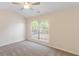 Bedroom with neutral carpet, a ceiling fan, and a large window with blinds at 2727 Parkway Trl, Lithonia, GA 30058