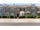 Close-up of a two-story brick townhome with manicured landscaping and an individual entrance at 2727 Parkway Trl, Lithonia, GA 30058