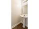 Simple powder room with a pedestal sink and updated fixtures, perfect for guests at 2727 Parkway Trl, Lithonia, GA 30058