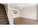 Open-concept living room with hardwood floors and view of staircase and kitchen at 2727 Parkway Trl, Lithonia, GA 30058