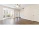 Bright living room featuring hardwood floors, a ceiling fan, and natural light from bay windows at 2727 Parkway Trl, Lithonia, GA 30058