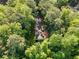 Aerial view of home nestled among lush greenery with a long driveway at 2984 E Paulding Dr, Dallas, GA 30157