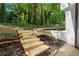 View of backyard featuring a set of wooden stairs and a white brick retaining wall at 2984 E Paulding Dr, Dallas, GA 30157