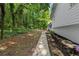 View of the home's backyard showing the lawn, trees, and white brick exterior at 2984 E Paulding Dr, Dallas, GA 30157