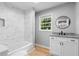 Modern bathroom with marble tile, a sleek vanity, and updated fixtures, offering a luxurious and stylish space at 2984 E Paulding Dr, Dallas, GA 30157