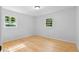 A light and airy bedroom featuring hardwood floors and natural light streaming through the windows, creating a serene space at 2984 E Paulding Dr, Dallas, GA 30157