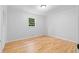 Clean bedroom featuring hardwood floors, natural light from the window, and a closet, providing a comfortable and minimalist space at 2984 E Paulding Dr, Dallas, GA 30157