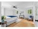 Bright bedroom featuring hardwood floors, two windows, and a ceiling fan at 2984 E Paulding Dr, Dallas, GA 30157
