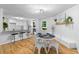Bright dining area with hardwood floors next to a breakfast bar and modern kitchen at 2984 E Paulding Dr, Dallas, GA 30157