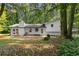 Rear exterior of home with landscaped yard and white brick and siding at 2984 E Paulding Dr, Dallas, GA 30157