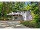 Two-story home featuring an attached covered parking area and lush green surroundings at 2984 E Paulding Dr, Dallas, GA 30157