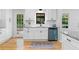 Updated kitchen with white cabinets, granite countertops, and hardwood floors, providing a clean and stylish cooking area at 2984 E Paulding Dr, Dallas, GA 30157