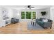 Sunlit living room with hardwood floors and a large window with views of lush greenery at 2984 E Paulding Dr, Dallas, GA 30157