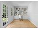 Home office with built-in shelves, desk, and a door to the outside, creating a functional and bright workspace at 2984 E Paulding Dr, Dallas, GA 30157