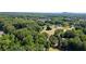 Picturesque aerial view showing lush greenery, homes, and vast land with distant mountains at 7376 Bates Dr, Cumming, GA 30040