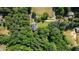 Overhead aerial view of home surrounded by lush greenery with neighborhood visible at 7376 Bates Dr, Cumming, GA 30040