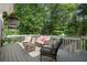Relaxing outdoor deck featuring comfortable wicker furniture and wooded views at 7376 Bates Dr, Cumming, GA 30040