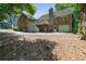 Beautiful brick home with a two-story deck overlooking a spacious backyard and garage at 7376 Bates Dr, Cumming, GA 30040