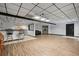 Spacious basement featuring a bar area, wood-look floors, and modern lighting at 7376 Bates Dr, Cumming, GA 30040