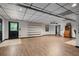 Bright, open basement with wood floors and neutral walls, ideal for flexible living at 7376 Bates Dr, Cumming, GA 30040