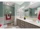 Stylish bathroom featuring a double vanity, wainscoting, and modern decor at 7376 Bates Dr, Cumming, GA 30040