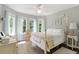 Cozy bedroom with natural light, hardwood floors, and charming decor at 7376 Bates Dr, Cumming, GA 30040