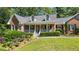 Beautiful brick home with dormer windows and a welcoming front porch at 7376 Bates Dr, Cumming, GA 30040