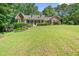 Charming brick home with a covered front porch and well-manicured landscaping at 7376 Bates Dr, Cumming, GA 30040