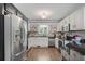 Well-equipped kitchen featuring stainless steel appliances and granite countertops at 7376 Bates Dr, Cumming, GA 30040