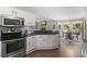 Bright kitchen with white cabinets, stainless steel appliances and hardwood floors at 7376 Bates Dr, Cumming, GA 30040