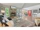Bright living area featuring a stone fireplace, hardwood floors, and open layout at 7376 Bates Dr, Cumming, GA 30040