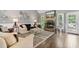 Cozy living room with stone fireplace, hardwood floors, and natural light at 7376 Bates Dr, Cumming, GA 30040