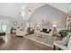 Spacious living room featuring vaulted ceilings, hardwood floors, and abundant natural light at 7376 Bates Dr, Cumming, GA 30040