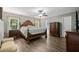 Spacious main bedroom with a ceiling fan and hardwood floors at 7376 Bates Dr, Cumming, GA 30040