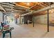 Unfinished basement with cement floors and exposed beams providing a blank slate at 8415 Ridge Rd, Fairburn, GA 30213