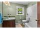 Cozy bathroom featuring tub, tiled floors, sink with vanity, and natural light at 8415 Ridge Rd, Fairburn, GA 30213