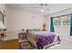 Relaxing bedroom features hardwood floors, ceiling fan, and natural light from large window at 8415 Ridge Rd, Fairburn, GA 30213