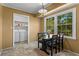 Cozy dining area with breakfast nook and laundry room entrance provides natural light and tiled floors at 8415 Ridge Rd, Fairburn, GA 30213