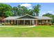 Charming brick ranch-style home with a well-manicured lawn and inviting covered porch at 8415 Ridge Rd, Fairburn, GA 30213