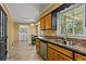 Charming eat-in kitchen features natural light, oak cabinets, stainless steel appliances, and tiled floor at 8415 Ridge Rd, Fairburn, GA 30213