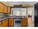 Spacious kitchen with view into the living area, stainless steel appliances, and wood cabinets at 8415 Ridge Rd, Fairburn, GA 30213