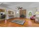 Cozy living room featuring a brick fireplace, hardwood floors, and abundant natural light at 8415 Ridge Rd, Fairburn, GA 30213