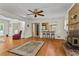 Open concept living room with a fireplace, hardwood floors, and bar seating to kitchen at 8415 Ridge Rd, Fairburn, GA 30213
