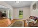 Bright sitting room featuring hardwood floors, natural light, and cozy seating area at 8415 Ridge Rd, Fairburn, GA 30213