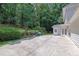 Home exterior featuring neutral siding and landscaping, including a concrete patio at 985 Laurel Springs Ln, Marietta, GA 30064