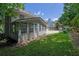Home exterior featuring a sunroom and large concrete patio at 985 Laurel Springs Ln, Marietta, GA 30064